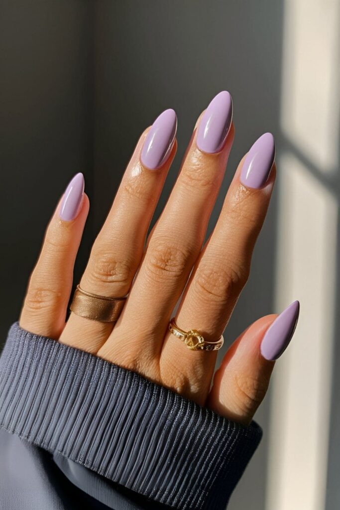 Nails painted in a soft lilac shade, adding a gentle and sophisticated touch with a light purple color for a refined design