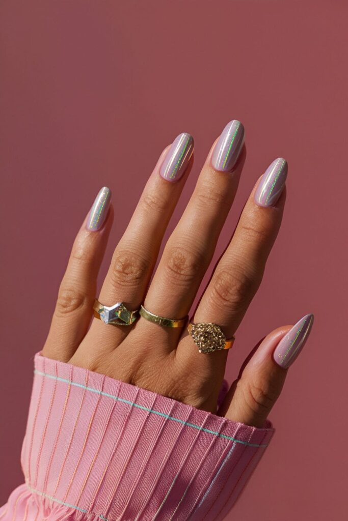 Nails with a solid base color, decorated with holographic stripes in straight or diagonal patterns, reflecting light beautifully