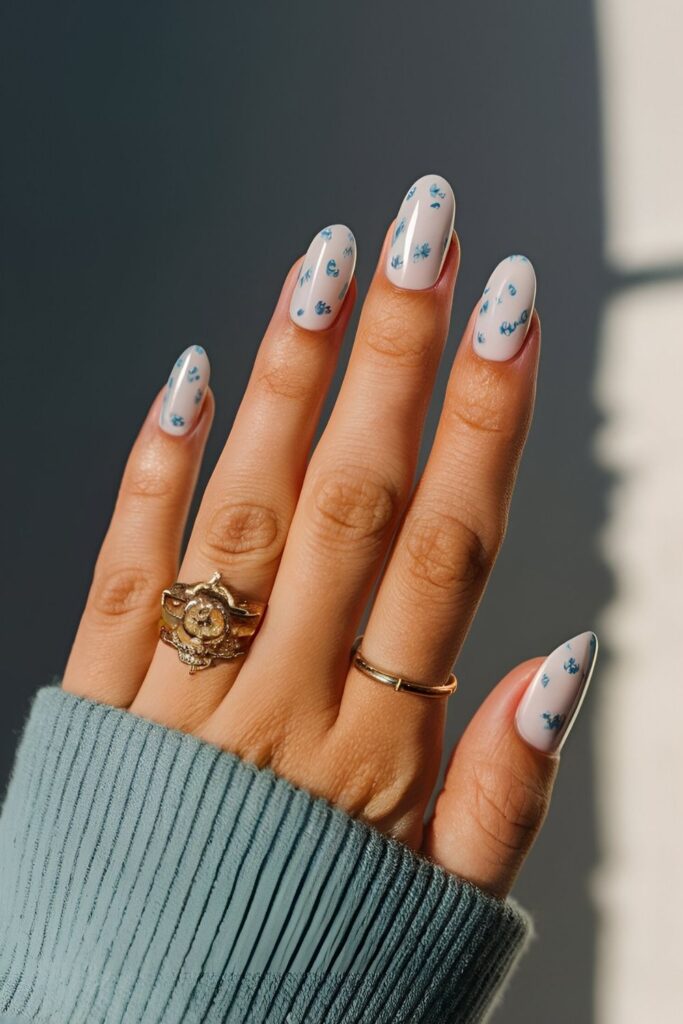 Nails-with-a-white-base-featuring-delicate-blue-patterns-resembling-traditional-porcelain