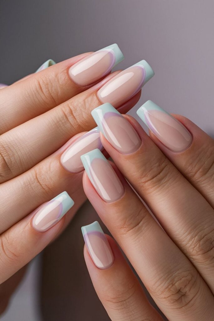 Nails with pastel French tips in shades of pink, lavender, and mint on a soft nude or clear base perfect for spring