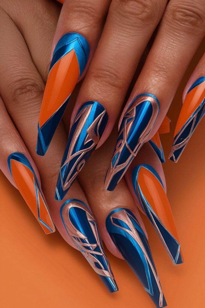 Nails with striking metallic blue accents or patterns on an orange base, bold and eye-catching nail design