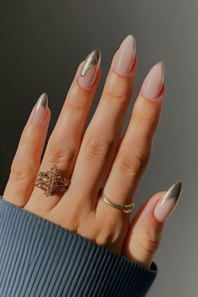 Neutral base acrylic nails with touches of gold or silver metallic accents, adding a hint of luxury