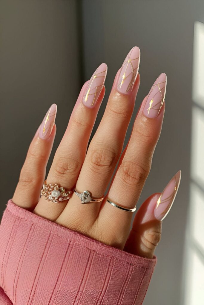 Nude or pink nails with delicate fine lines of gold or silver, and tiny dot accents resembling fairy lights

