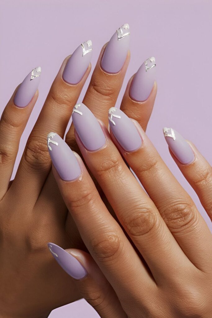 Pale lavender nails with a frosted finish and delicate white or silver accents for a soft, ethereal look