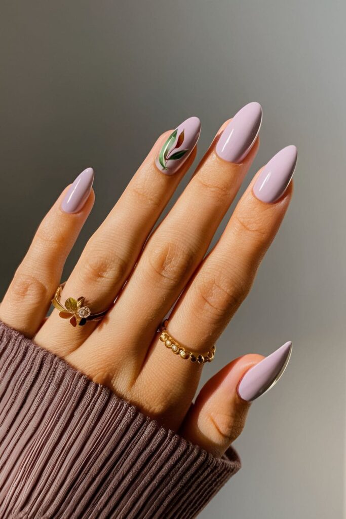 Pale lavender nails with delicate green and brown leaves, creating a serene fall look