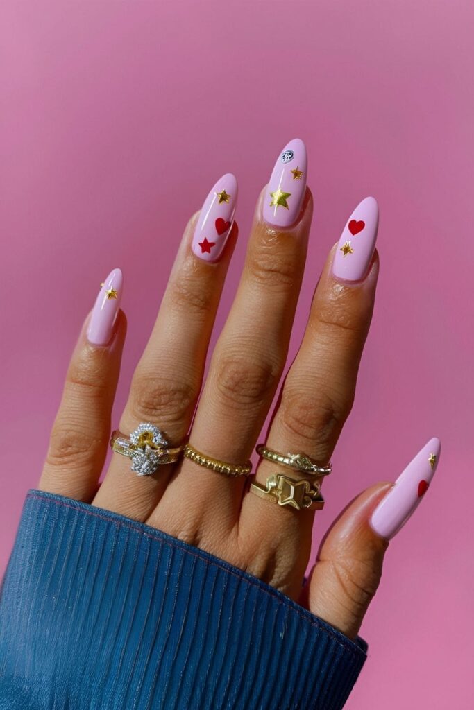 Pastel nails adorned with tiny star, heart, and dot embellishments creating a cute and trendy look