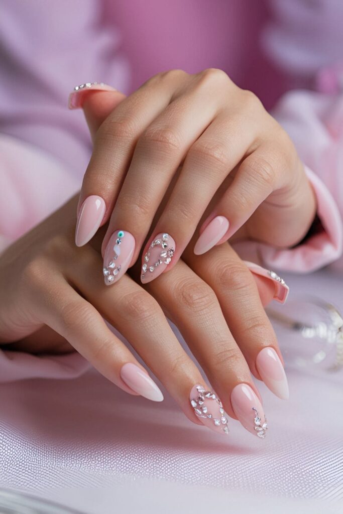 Pink acrylic nails adorned with sparkling diamond rhinestones and crystal designs