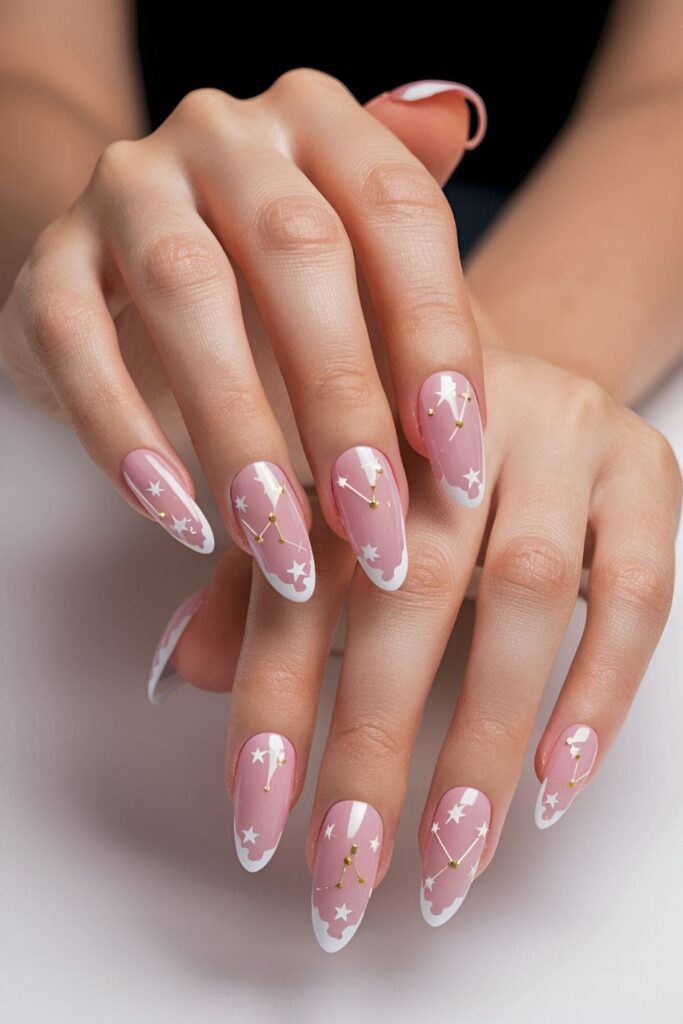 Pink acrylic nails with tiny white and gold star and constellation designs