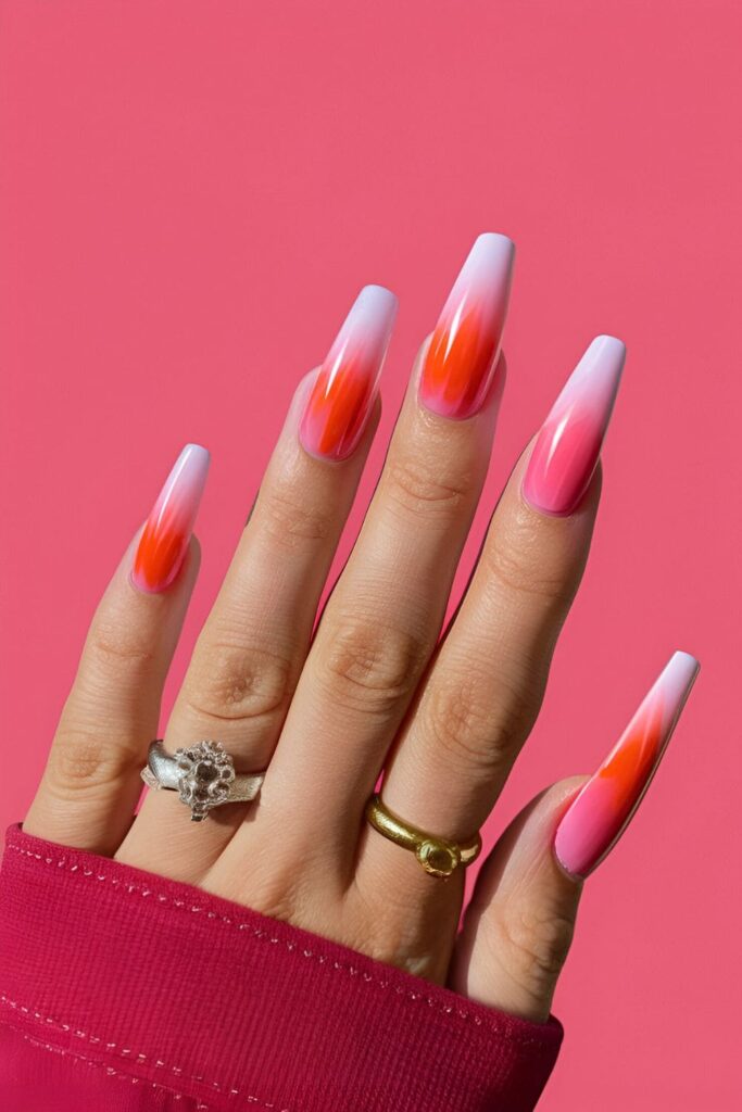 Pink coffin nails with a gradient effect blending pink and orange to mimic a sunset