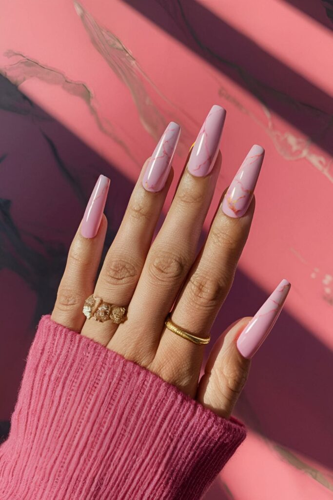 Pink coffin nails with a marble effect, mimicking natural marble veining