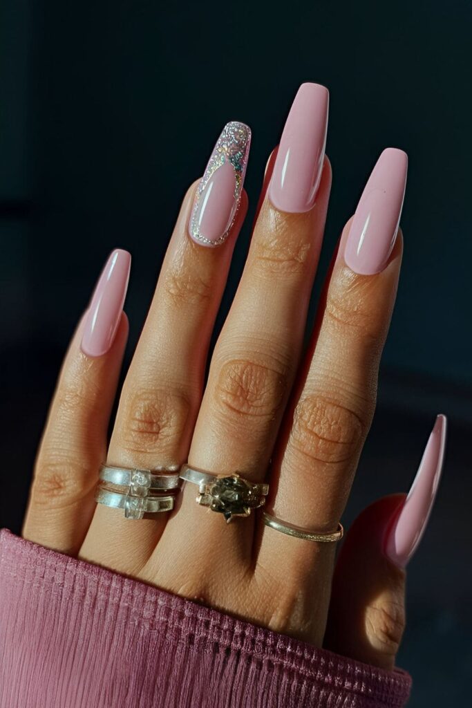 Pink coffin nails with a thin line of glitter polish around the cuticles