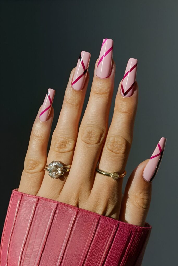 Pink coffin nails with bold and subtle striped patterns in white, black, and pink