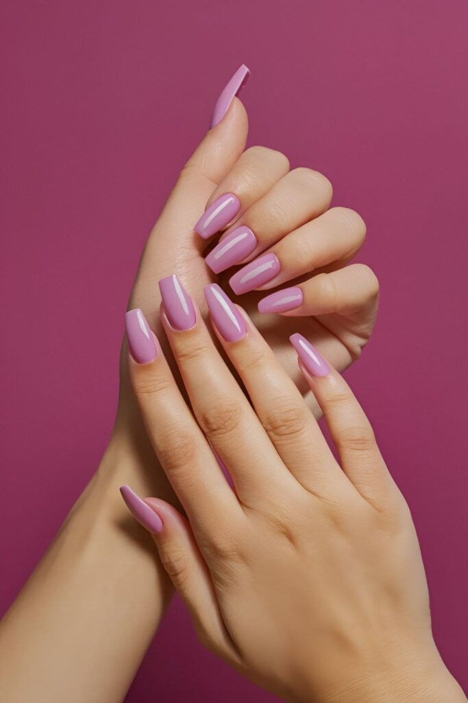 Pink coffin nails with mauve accents, creating ombre effects and stripes