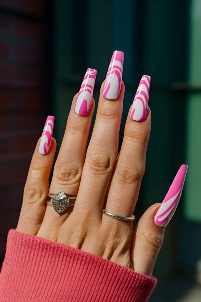 Pink coffin nails with whimsical swirls of pink and white