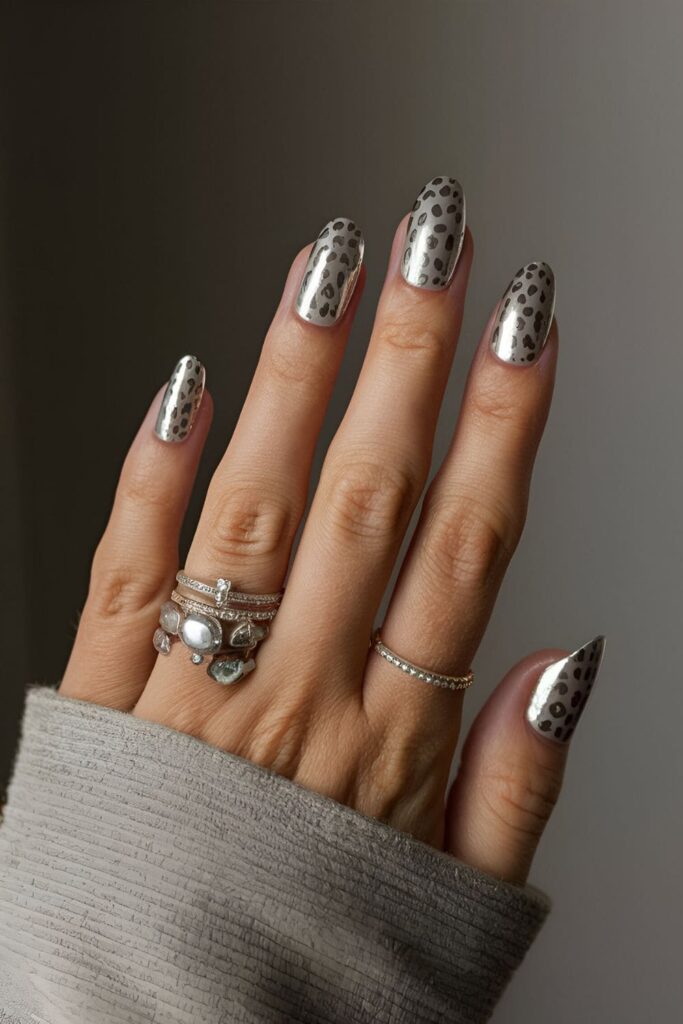 Playful silver leopard print on nails, with leopard spots created using silver polish on a nude or colored base