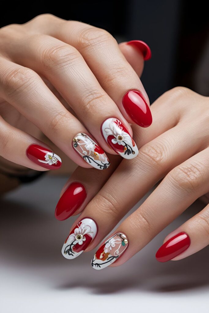 Red manicure with delicate white, black, and gold floral designs scattered across the nails, adding a feminine and romantic touch