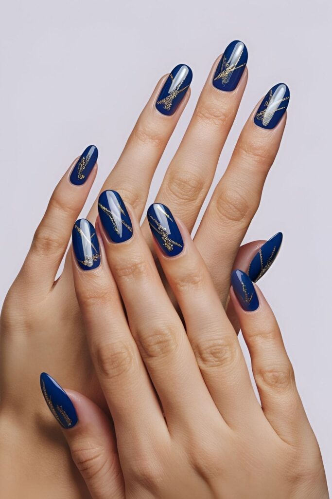 Royal blue nails with gold stripes or designs, combining blue and gold for a luxurious, eye-catching look with elegant gold accents