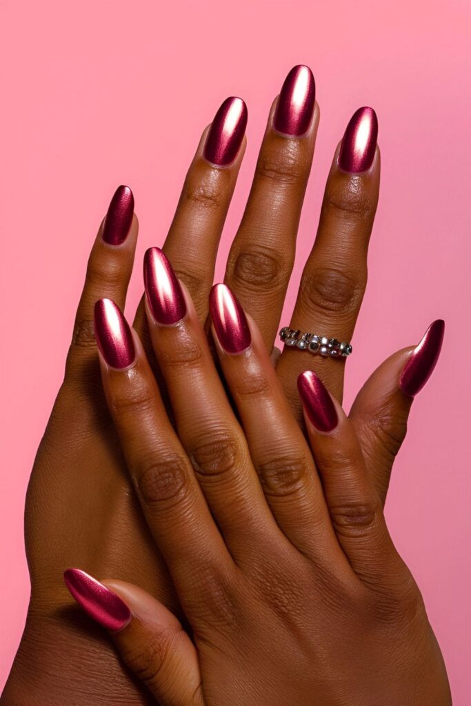 Shiny pink metallic acrylic nails with a futuristic look, specifically chosen for dark skin tones