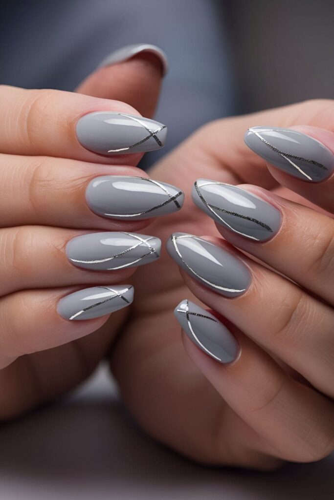 Soft gray nails with delicate silver lines, creating a sophisticated silver lining effect