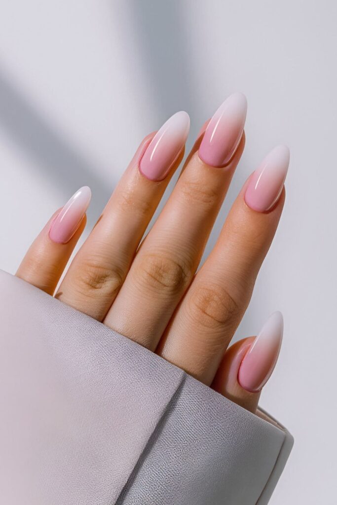 Soft pink and white ombre acrylic nails creating a delicate, dreamy gradient