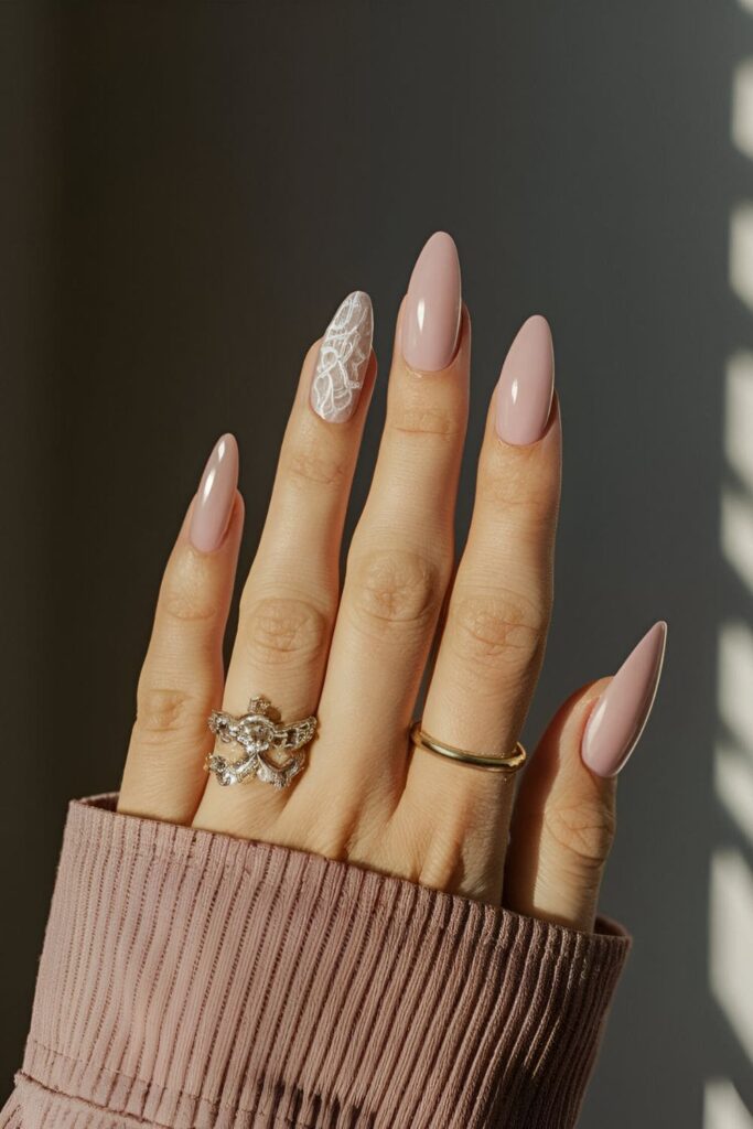 Soft pink coffin nails with delicate white lace patterns