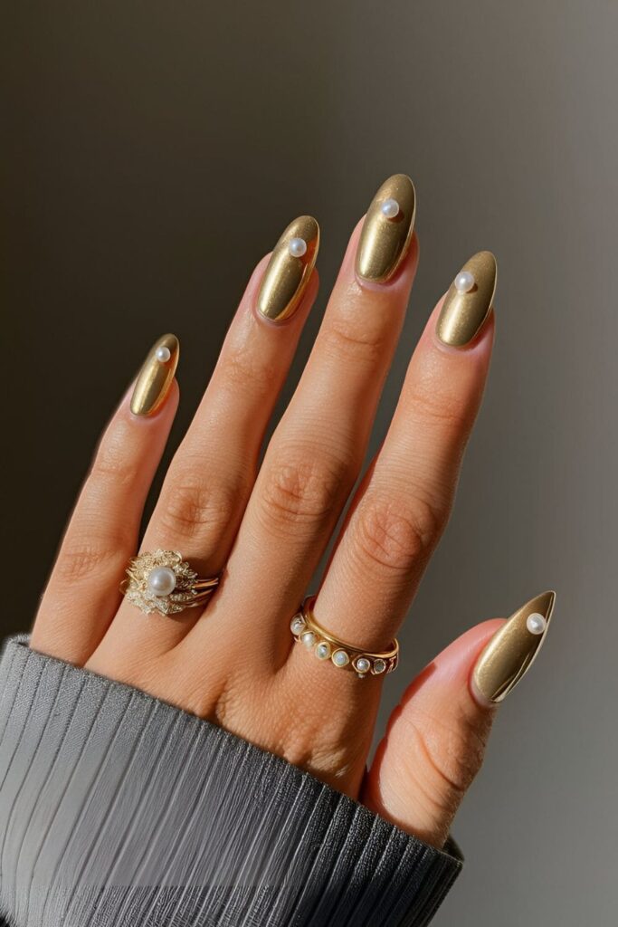 Sophisticated gold acrylic nails with tiny pearl accents, ideal for formal events and high-end occasions