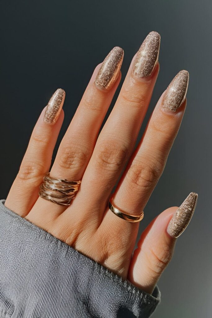 Sparkling gold glitter acrylic nails, perfect for parties and special events, adding a fun and elegant shine