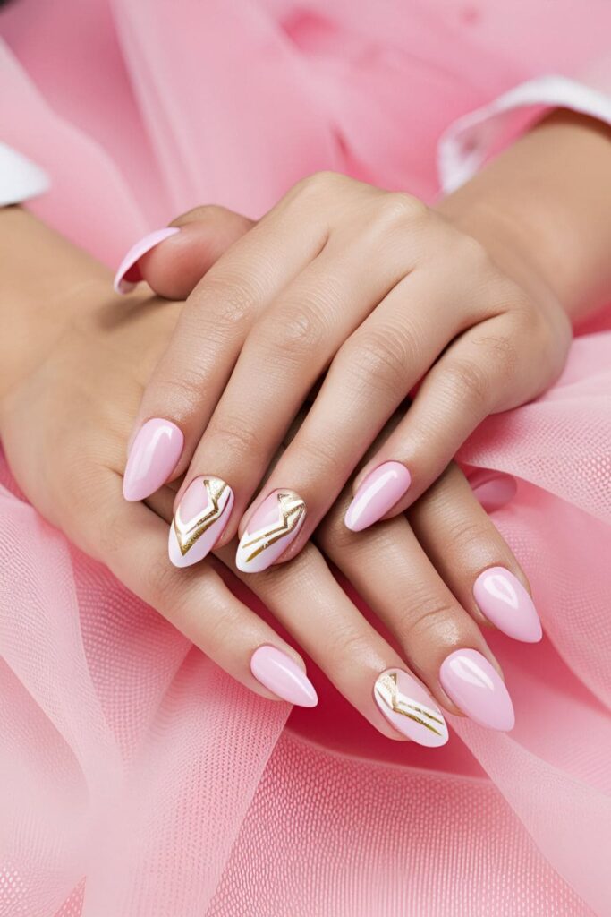 Stylish pink acrylic nails with white and gold chevron pattern designs