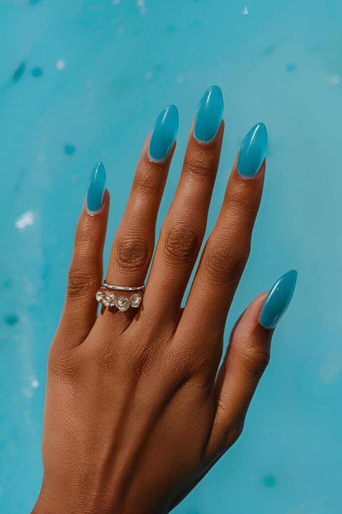 Transparent aqua blue jelly nails with a fun, gummy-like appearance