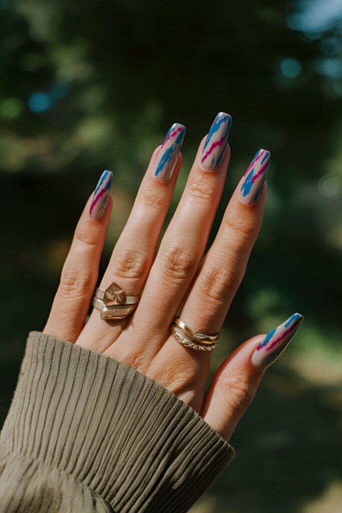 Trendy Ikat print nails with bold, blurred zigzag patterns