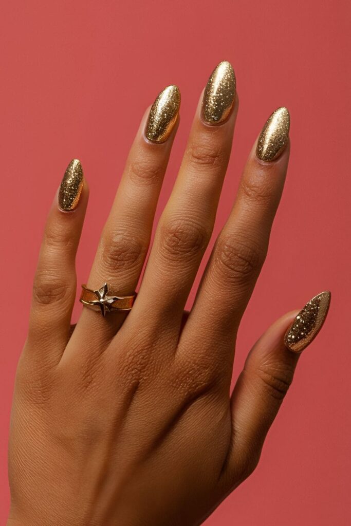 Unique gold acrylic nails with glitter applied to the cuticles, perfect for parties and special occasions