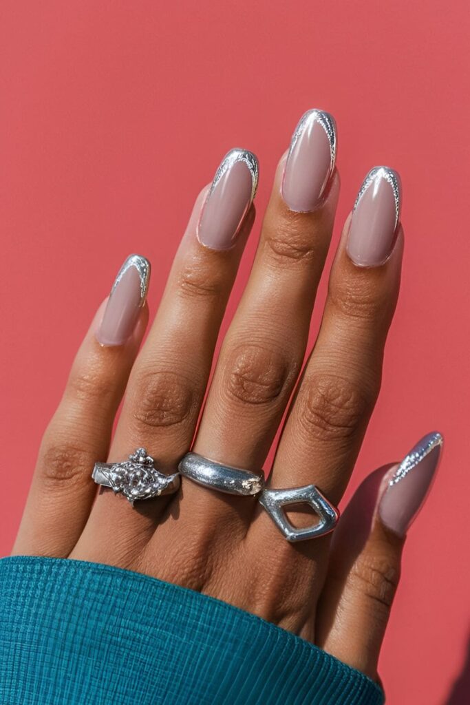 Unique nail design with a solid base color and silver polish outlining the edges for a modern touch