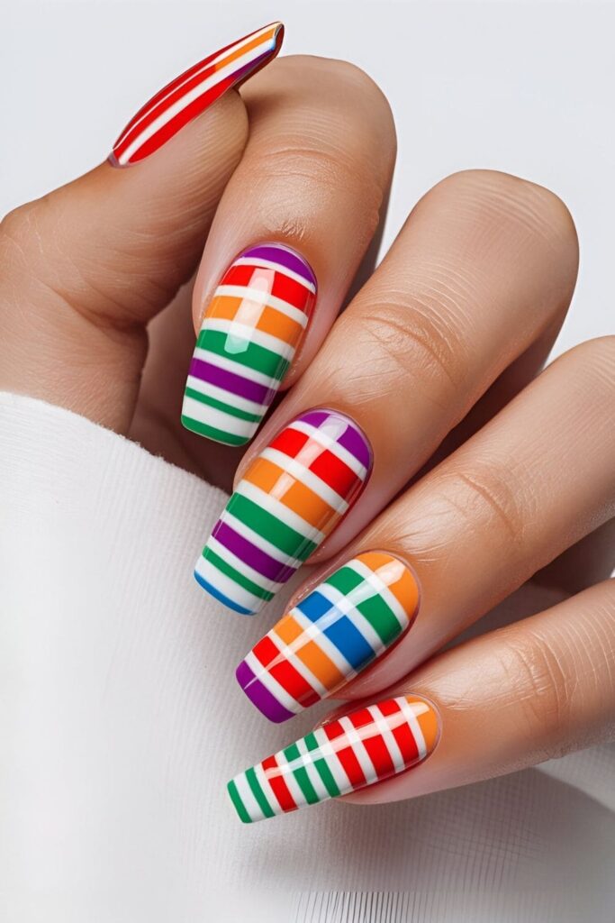 White nails featuring vibrant rainbow-colored stripes