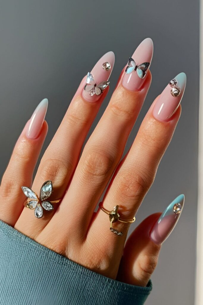 Delicate butterfly design acrylic nails with rhinestones on the wings, using soft pastel colors for a whimsical and enchanting effect