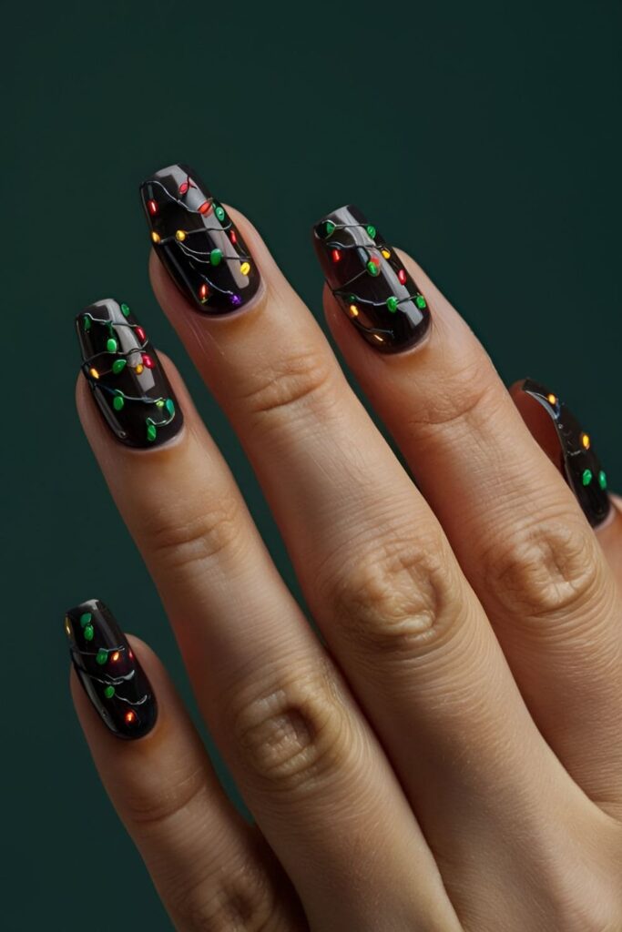 Acrylic nails with a dark base and tiny, colorful Christmas lights strung across the nails