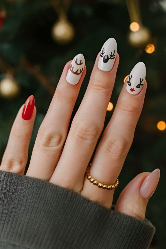 Acrylic nails with reindeer antlers painted on one or two nails, with some featuring full reindeer faces