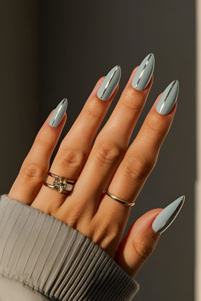 Icy blue nails decorated with sleek silver lines in horizontal, vertical, or diagonal geometric patterns