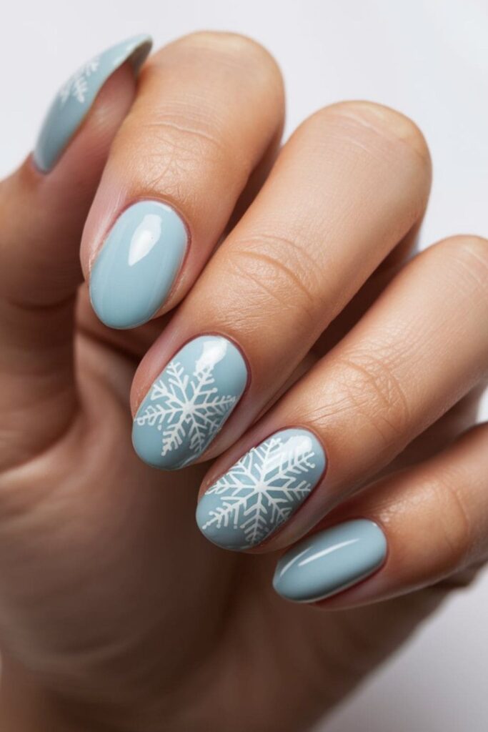 Ombré nails transitioning from soft gray to pure white, with glitter at the tips mimicking snow sparkle