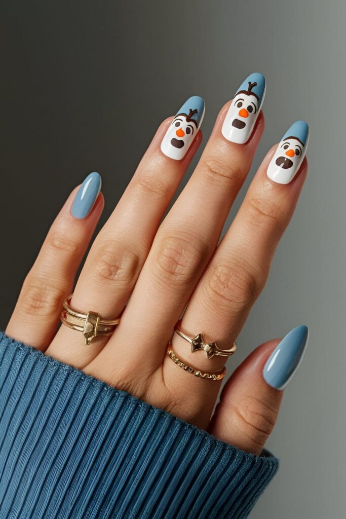 Playful winter-themed nails featuring a cute Olaf design from Frozen on a blue background