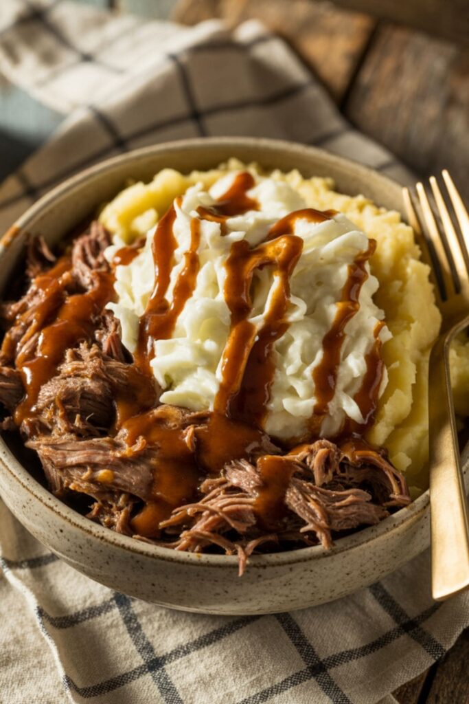 Barbecue shredded beef bowl with mashed potatoes and creamy coleslaw