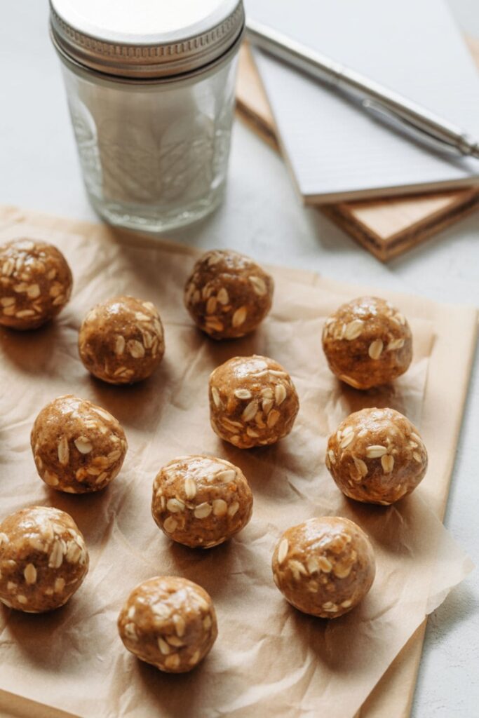 Homemade energy balls with oats and nut butter placed neatly on parchment paper