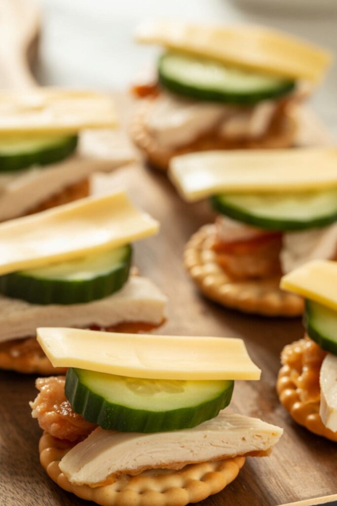 Mini sandwich stackers with cheese and deli meat on crackers