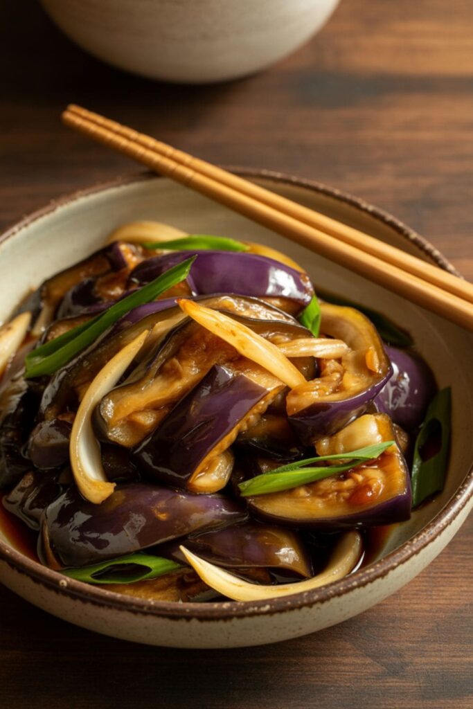 Stir-fried eggplant and onions in soy sauce garnished with sesame seeds